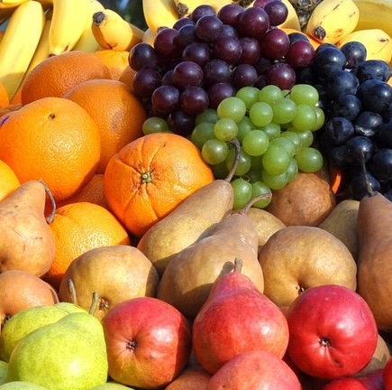 Different kinds of fruit piled in the sunshine